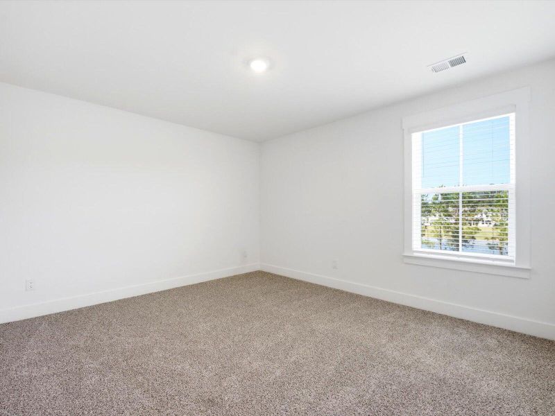 Spacious, unfurnished interior of a new home in The Coves at Lakes of Cane Bay II, Summerville (Image 28).