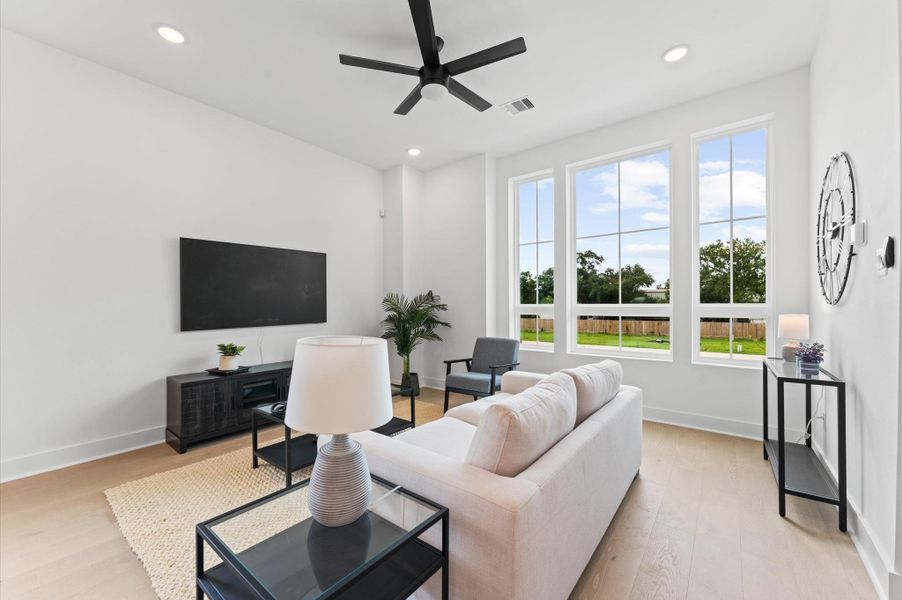 This thoughtfully designed two-story residence features a unique layout that places the living room, kitchen, and dining area on the second floor, creating a bright and airy space ideal for entertaining. Expansive windows flood the open-concept floor with natural light, while sleek finishes and modern fixtures add a touch of sophistication.