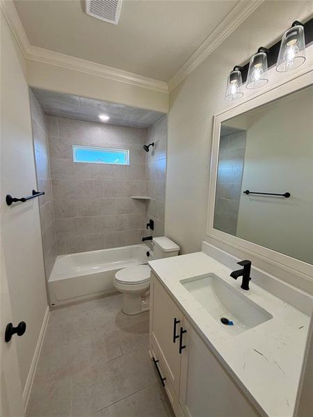 Bathroom featuring vanity, shower / bath combination, and crown molding Bathroom featuring vanity, shower / bath combination, and crown molding