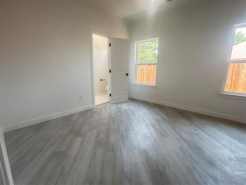 Spare room with wood-type flooring and a wealth of natural light