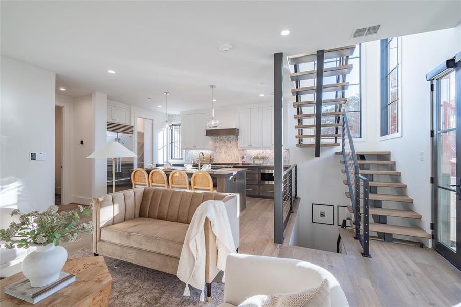 Living room featuring sink and light hardwood / wood-style flooring