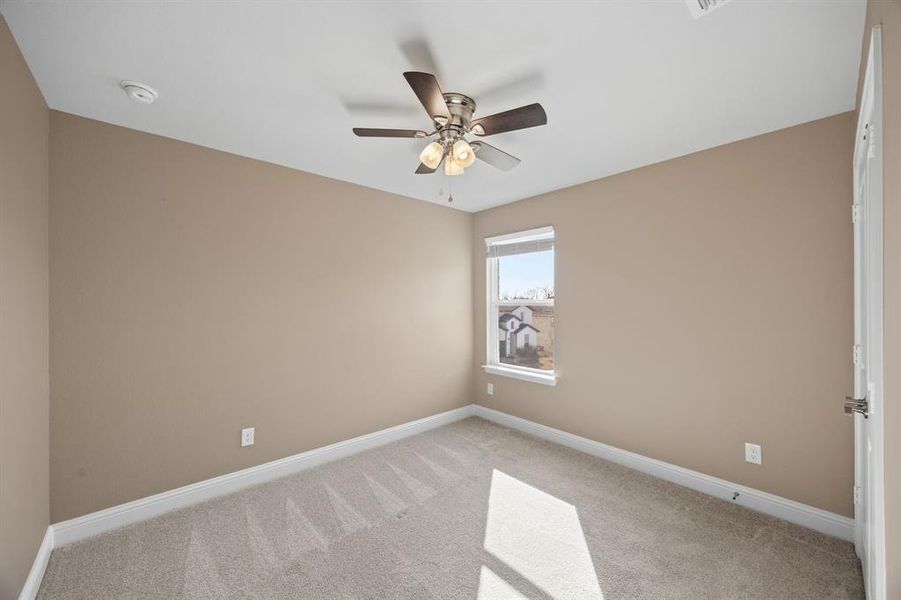 2nd level bedroom  featuring light colored carpet and ceiling fan