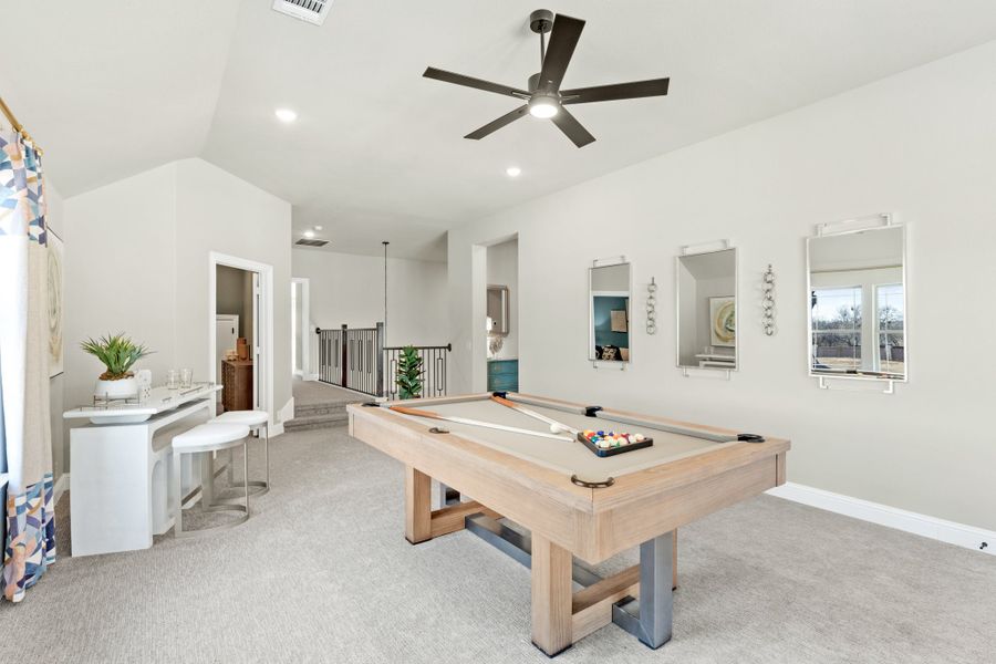 Game room with pool table, vaulted ceiling, ceiling fan, and carpet flooring Game room with pool table, vaulted ceiling, ceiling fan, and carpet flooring