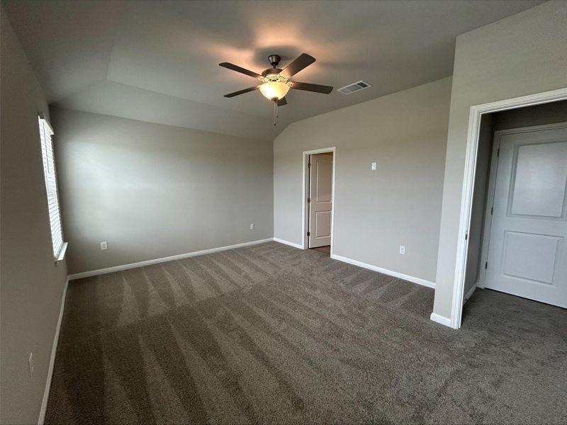 Unfurnished bedroom featuring carpet and a ceiling fan Unfurnished bedroom featuring carpet and a ceiling fan
