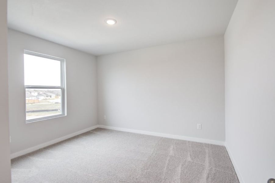 A room with a window and a carpet. A room with a window and a carpet.