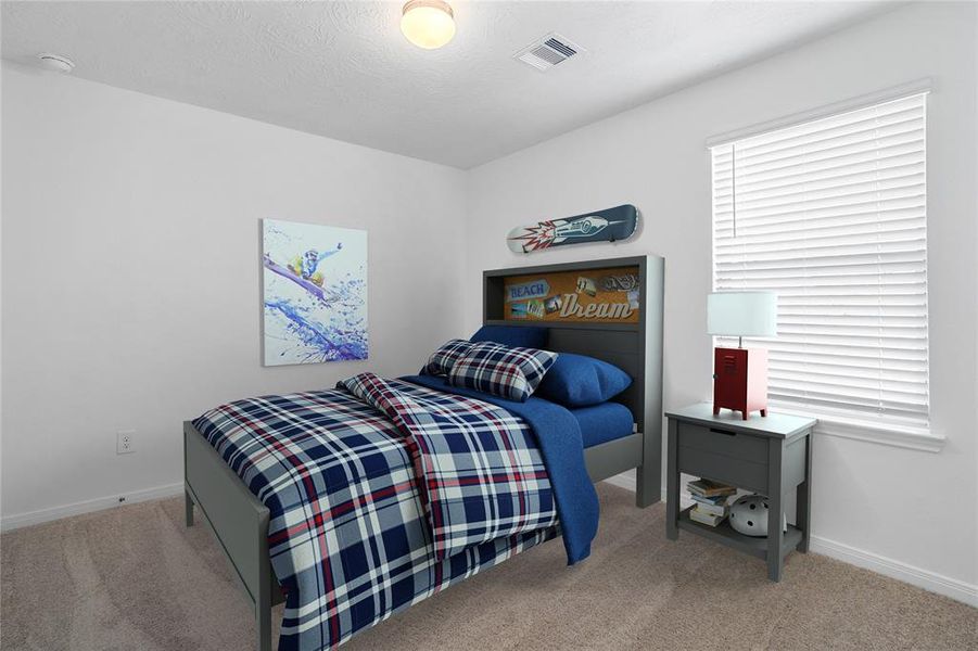 Secondary bedroom features plush carpet, custom paint, lighting, ample closet space, and a large window with privacy blinds.