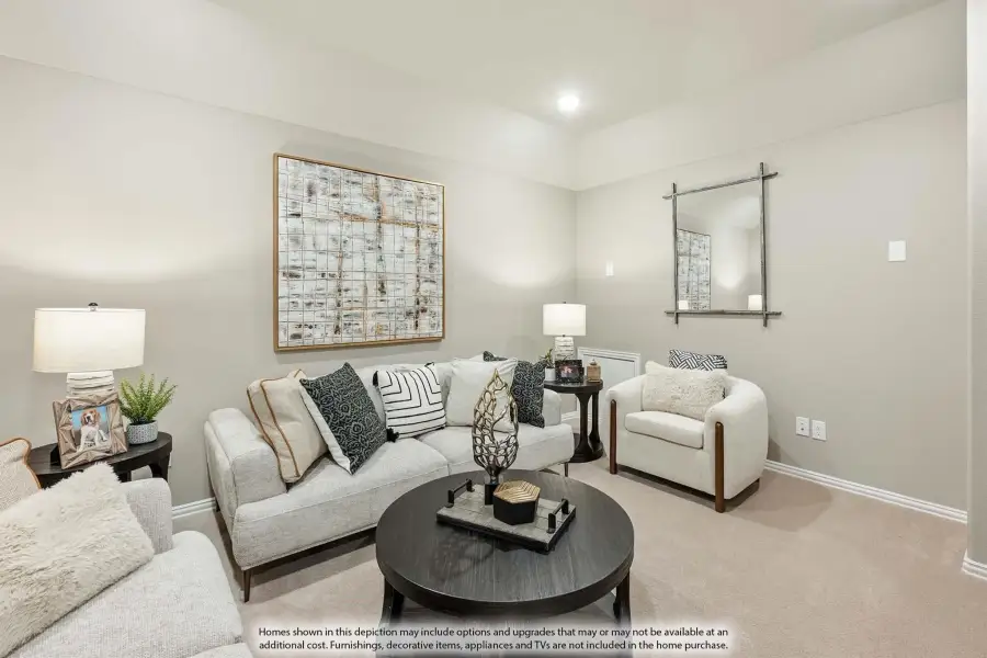 Living room with light gray sofa, round dark coffee table, accent chair, and large wall art on beige carpet