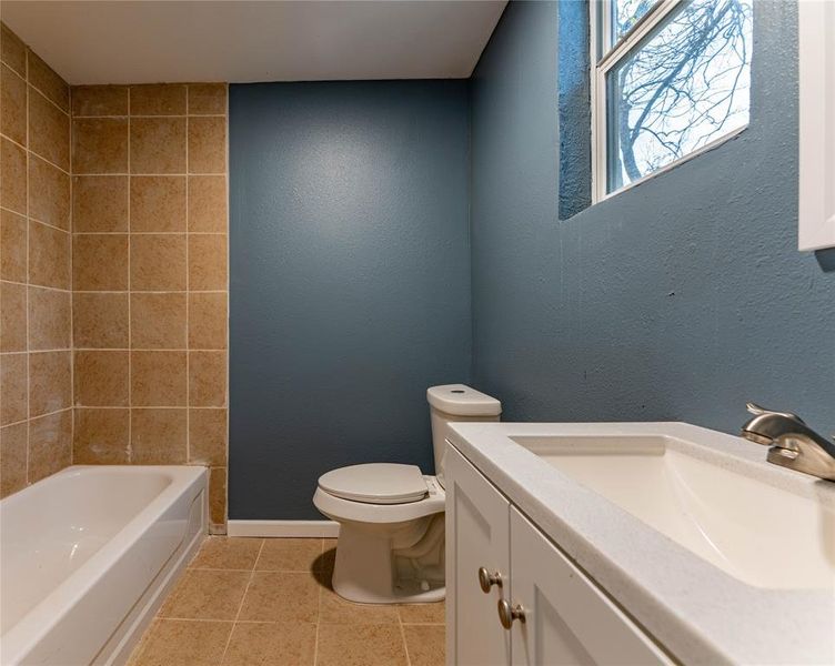 Bathroom featuring tile patterned flooring, vanity, and toilet Bathroom featuring tile patterned flooring, vanity, and toilet