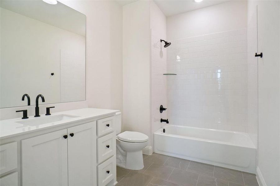 Bathroom featuring vanity, shower / tub combination, and tile patterned flooring Bathroom featuring vanity, shower / tub combination, and tile patterned flooring