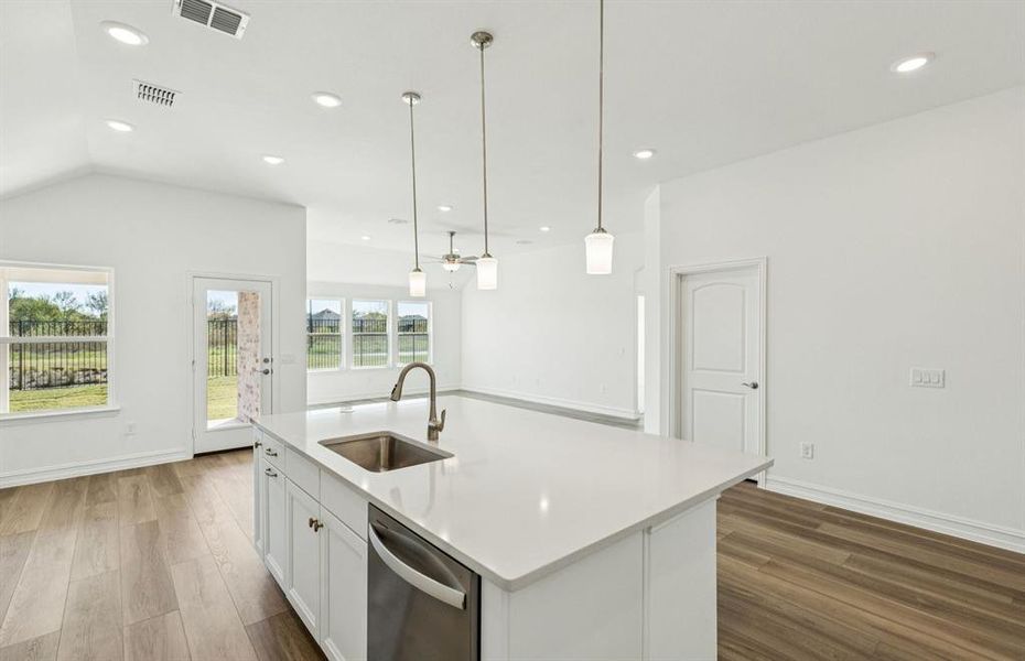 Large island overlooking gathering room and dining areas Large island overlooking gathering room and dining areas