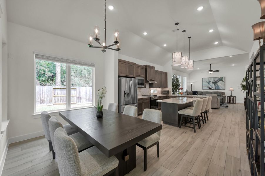 Additional view of the open-concept kitchen and dining space showcasing the seamless flow into the spacious living room, along with upgraded finishes and designer touches throughout.