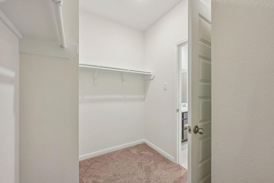 This spacious walk-in closet offers ample storage and organization potential for your wardrobe and accessories.