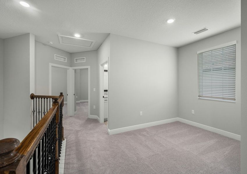 Upstairs loft with carpet flooring