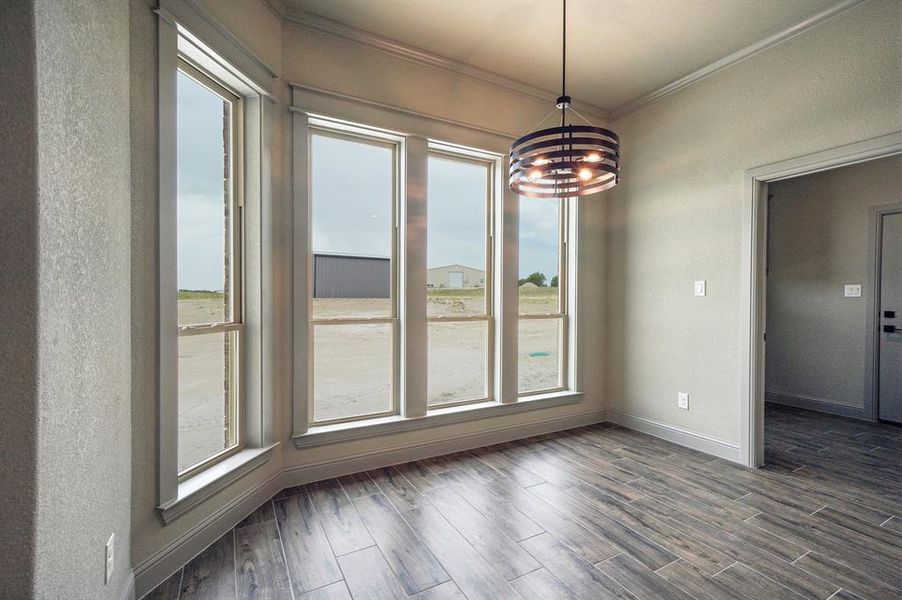 Kitchen nook area with crown molding and accent lighting.