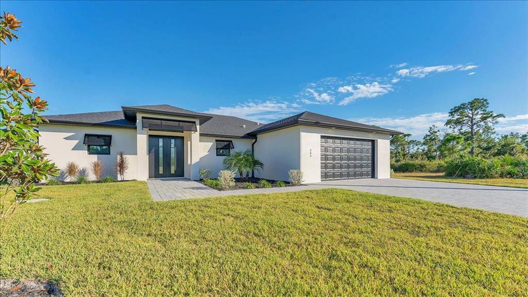 Front exterior of a new home in , Placida, FL, highlighting curb appeal (Image 1). Front exterior of a new home in , Placida, FL, highlighting curb appeal (Image 1).
