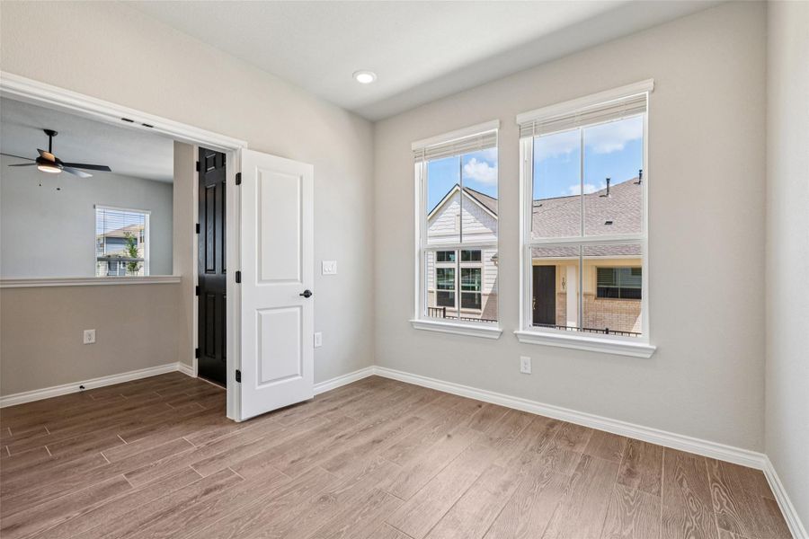 Empty room with wood finished floors, baseboards, a ceiling fan, and recessed lighting Empty room with wood finished floors, baseboards, a ceiling fan, and recessed lighting