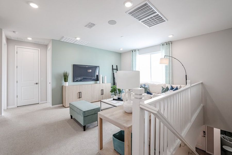 A living room with a white staircase. A living room with a white staircase.