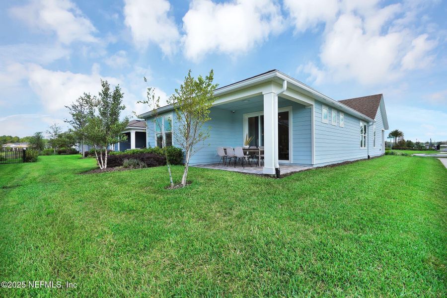 Front exterior of a new home in Summer Bay at Grand Oaks, St. Augustine, FL, highlighting curb appeal (Image 1).
