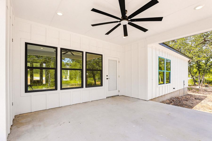 An inviting covered patio offers outdoor living space and peaceful  natural views.