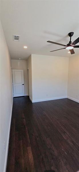 Spare room with dark wood-style floors, ceiling fan, and recessed lighting Spare room with dark wood-style floors, ceiling fan, and recessed lighting