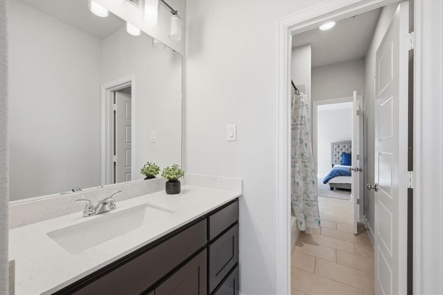 Full bathroom with vanity, a shower with curtain, light tile patterned flooring, and connected bathroom