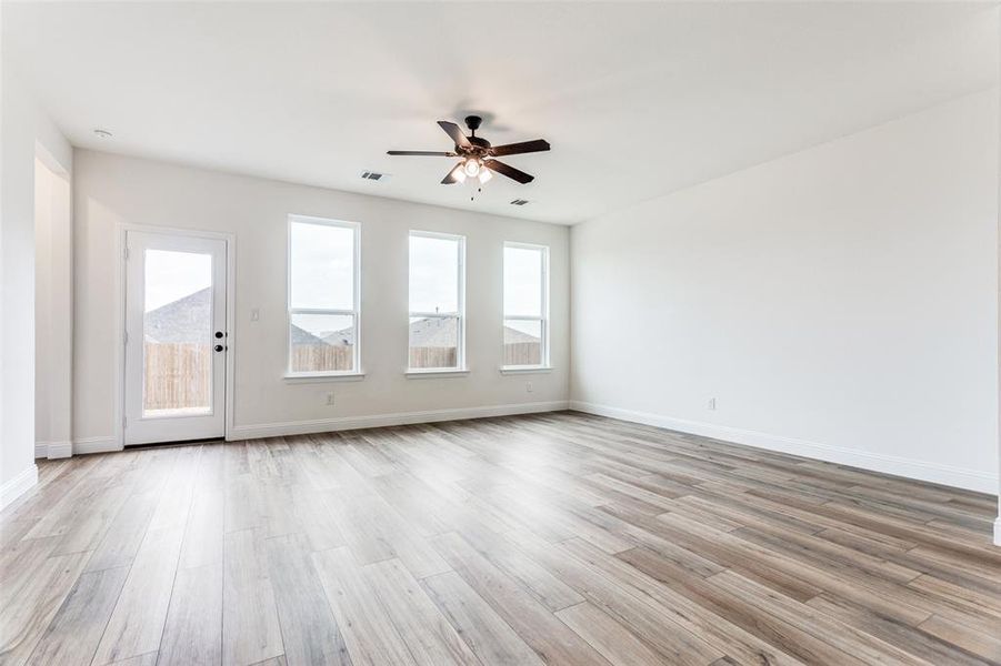 Unfurnished room with ceiling fan and light hardwood / wood-style floors