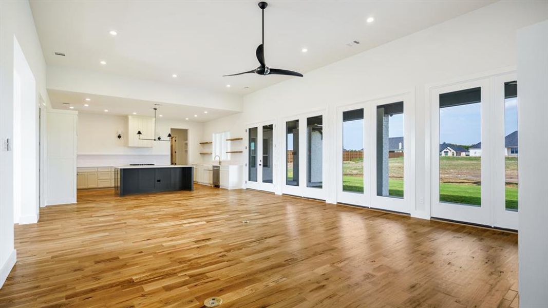 Unfurnished living room featuring light hardwood / wood-style floors and ceiling fan