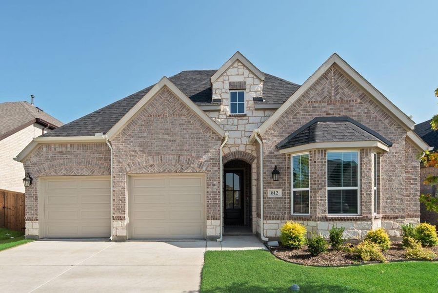 Front exterior of a new home in Wildflower Ranch, Justin, TX, highlighting curb appeal (Image 21). Front exterior of a new home in Wildflower Ranch, Justin, TX, highlighting curb appeal (Image 21).