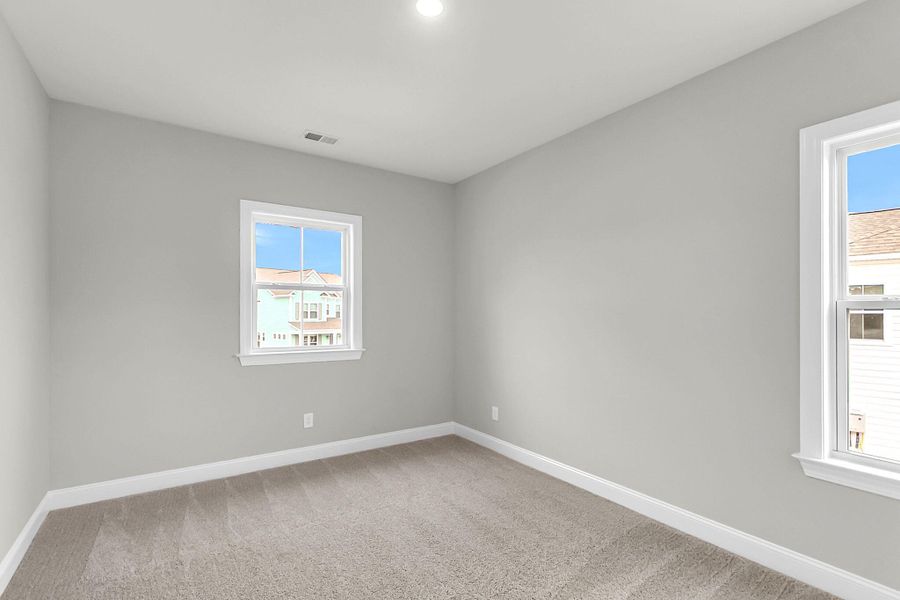 Spacious, unfurnished interior of a new home in Tidewater at Lakes of Cane Bay, Summerville (Image 31).