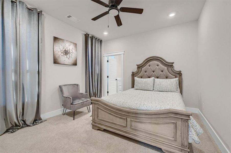 Carpeted bedroom with ceiling fan