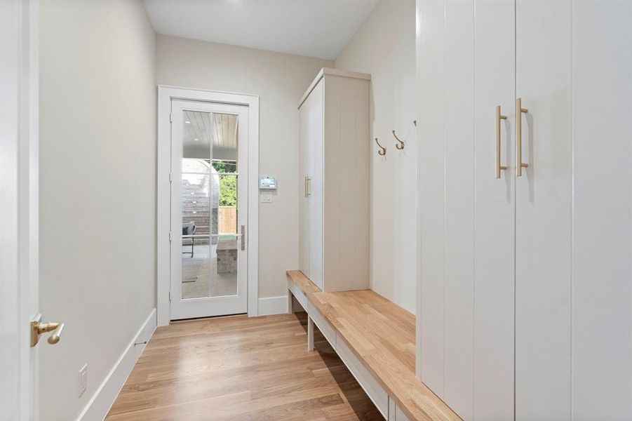 Mudroom with light hardwood / wood-style flooring