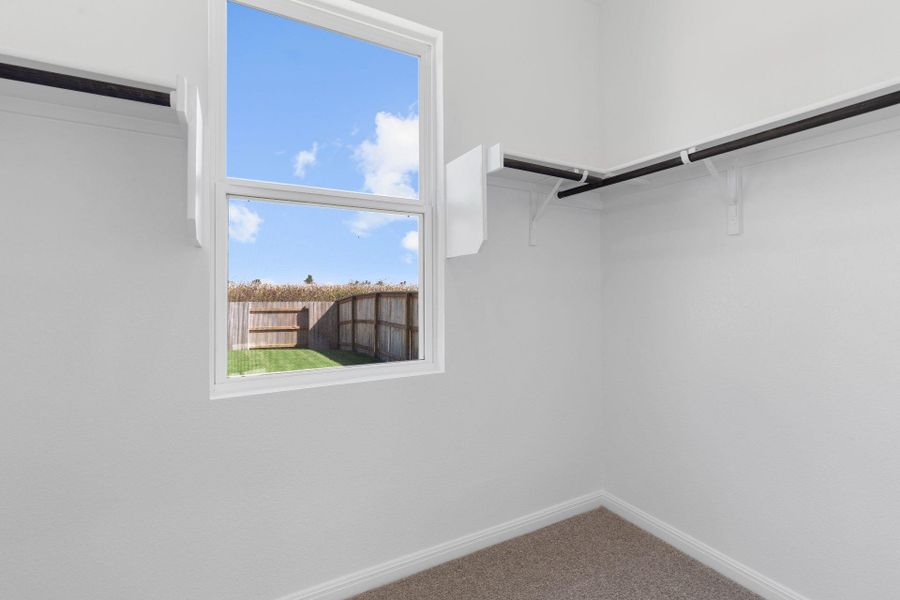 Walk-in closet in Primary Bedroom Walk-in closet in Primary Bedroom