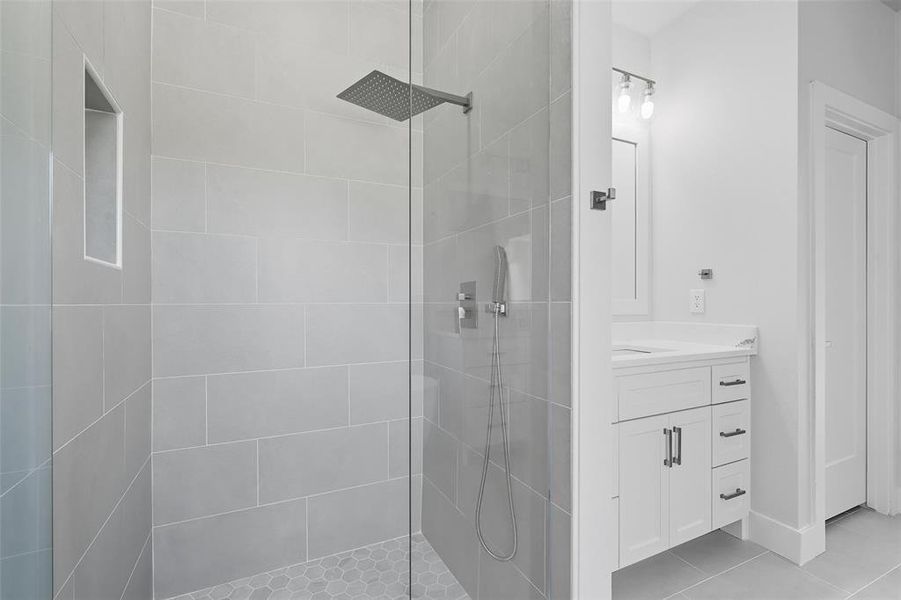 Full bathroom featuring a stall shower, light tile patterned floors, and vanity Full bathroom featuring a stall shower, light tile patterned floors, and vanity
