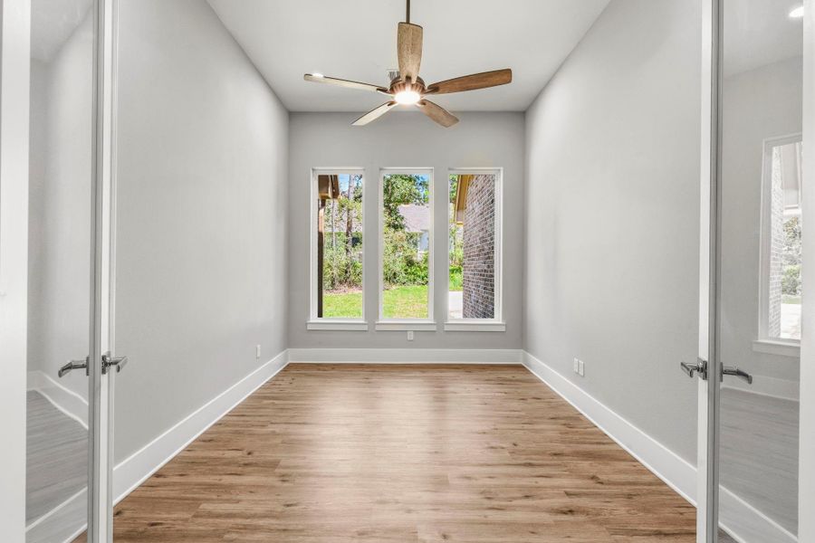 French doors create a private home office with natural light and a quiet setting for working, reading, and studying.
