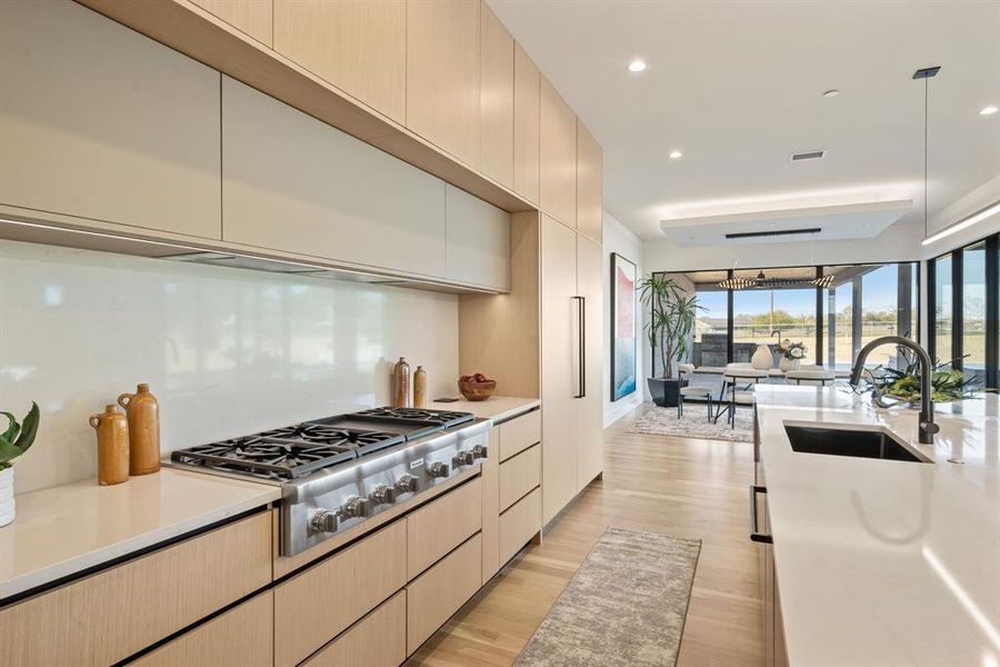 Expansive kitchen with custom storage, sleek finishes, and large prep spaces. Expansive kitchen with custom storage, sleek finishes, and large prep spaces.