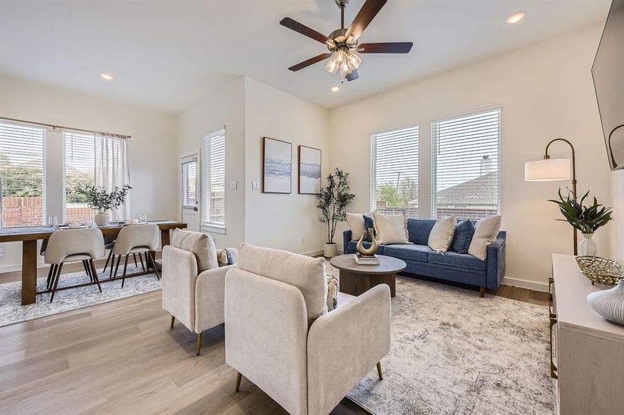 Living area featuring light wood finished floors, recessed lighting, and ceiling fan
