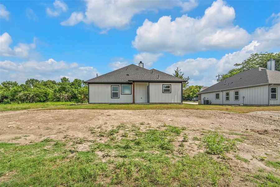 Rear view of property featuring a chimney Rear view of property featuring a chimney