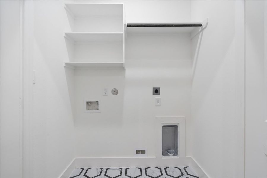 The utility room offers ample storage and functional space for laundry and organization. Its generous layout makes household tasks easy and efficient. This practical area combines convenience with thoughtful design, keeping the home organized and clutter-free.