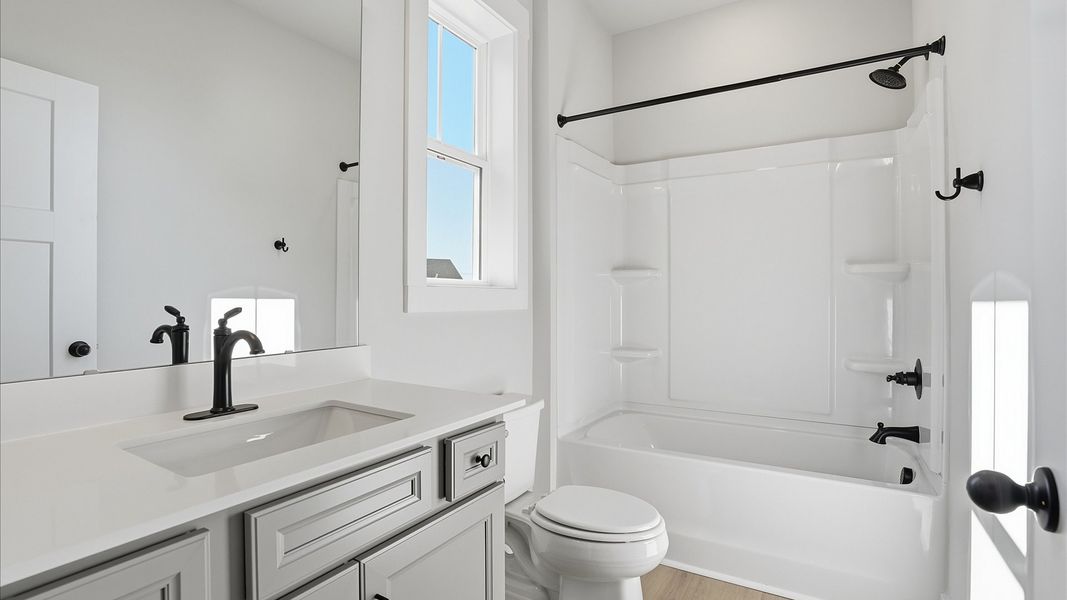 Vibrant and welcoming bathroom with elegant countertop space and polished details at Benjamin's Grove Vibrant and welcoming bathroom with elegant countertop space and polished details at Benjamin's Grove