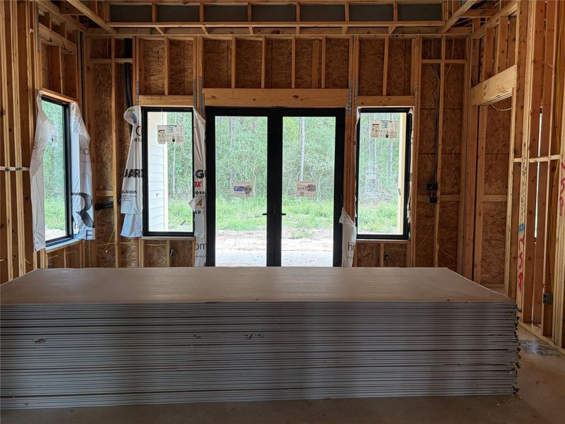 Newly constructed space featuring large windows and a glass door, offering abundant natural light and views of the surrounding greenery. Newly constructed space featuring large windows and a glass door, offering abundant natural light and views of the surrounding greenery.