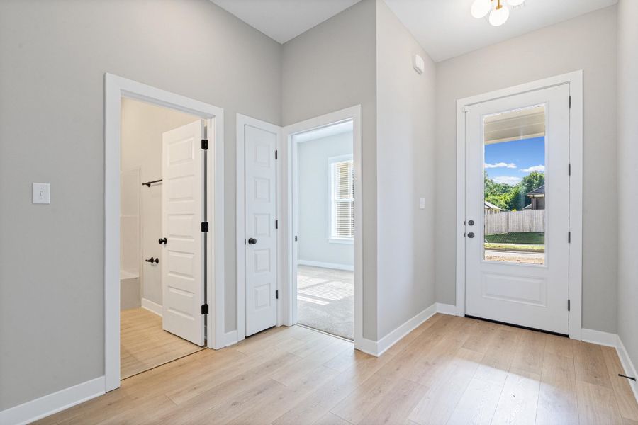 Entryway featuring light wood-finish flooring and a glass-paneled door