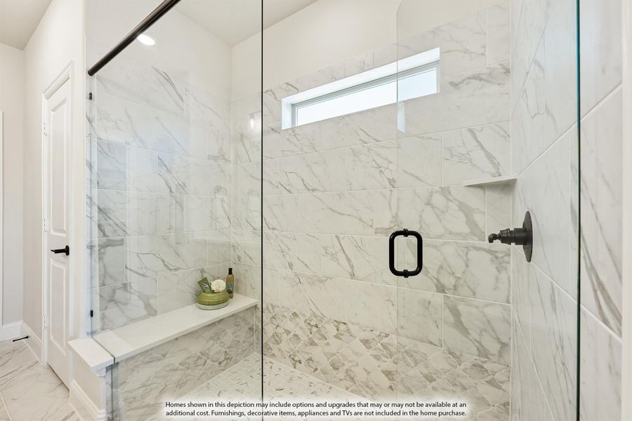 Walk-in shower with marble tile walls, glass door, built-in bench, and small window