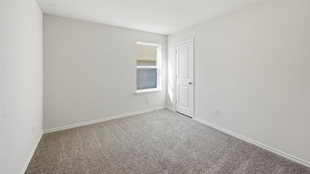 Unfurnished room featuring carpet floors and baseboards
