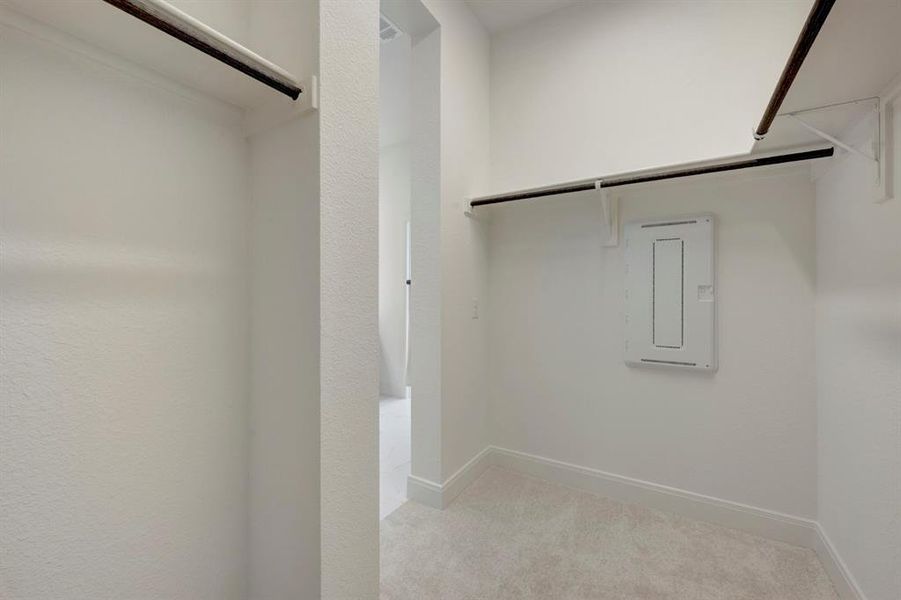 Walk in closet featuring light colored carpet Walk in closet featuring light colored carpet