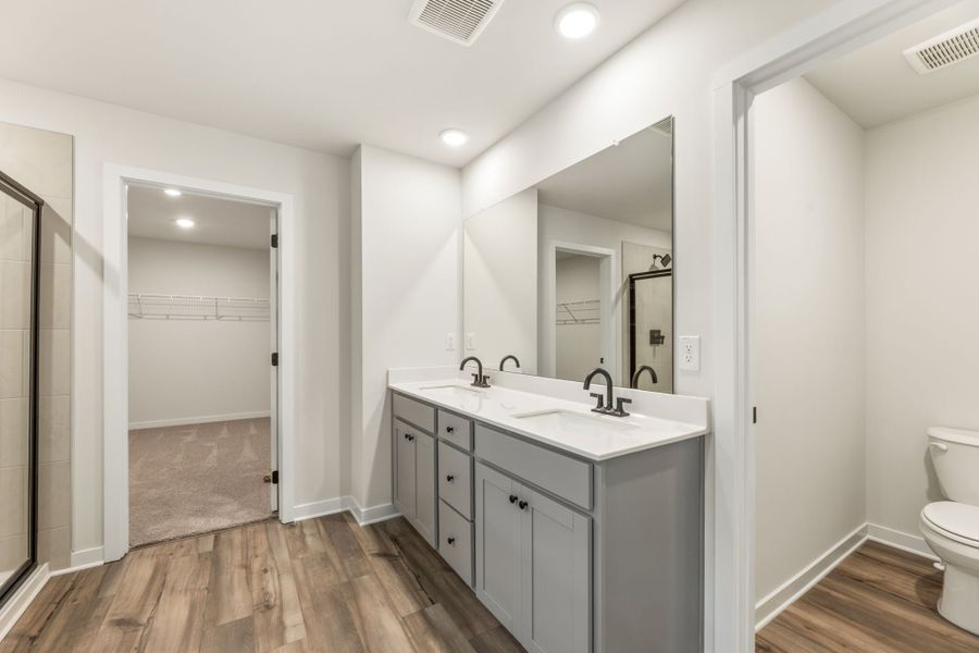 A bathroom with a sink and a toilet. A bathroom with a sink and a toilet.