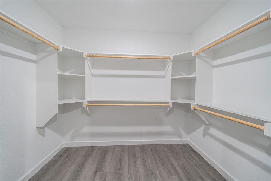 Spacious closet with dark wood finished floors Spacious closet with dark wood finished floors