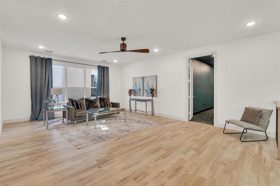 Living room featuring light hardwood / wood-style floors and ceiling fan