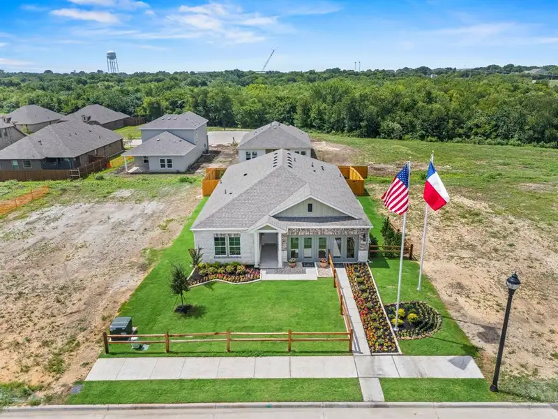Front exterior of a new home in MiraVerde, Crowley, TX, highlighting curb appeal (Image 21).