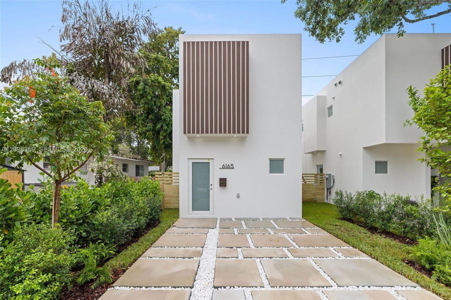 Front exterior of a new home in , South Miami, FL, highlighting curb appeal (Image 2). Front exterior of a new home in , South Miami, FL, highlighting curb appeal (Image 2).