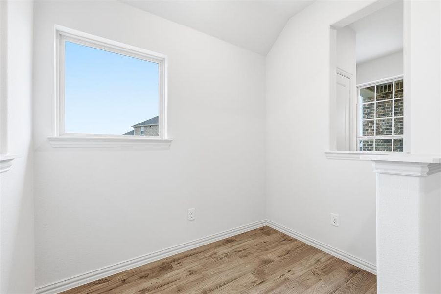 Spare room with wood finished floors and baseboards